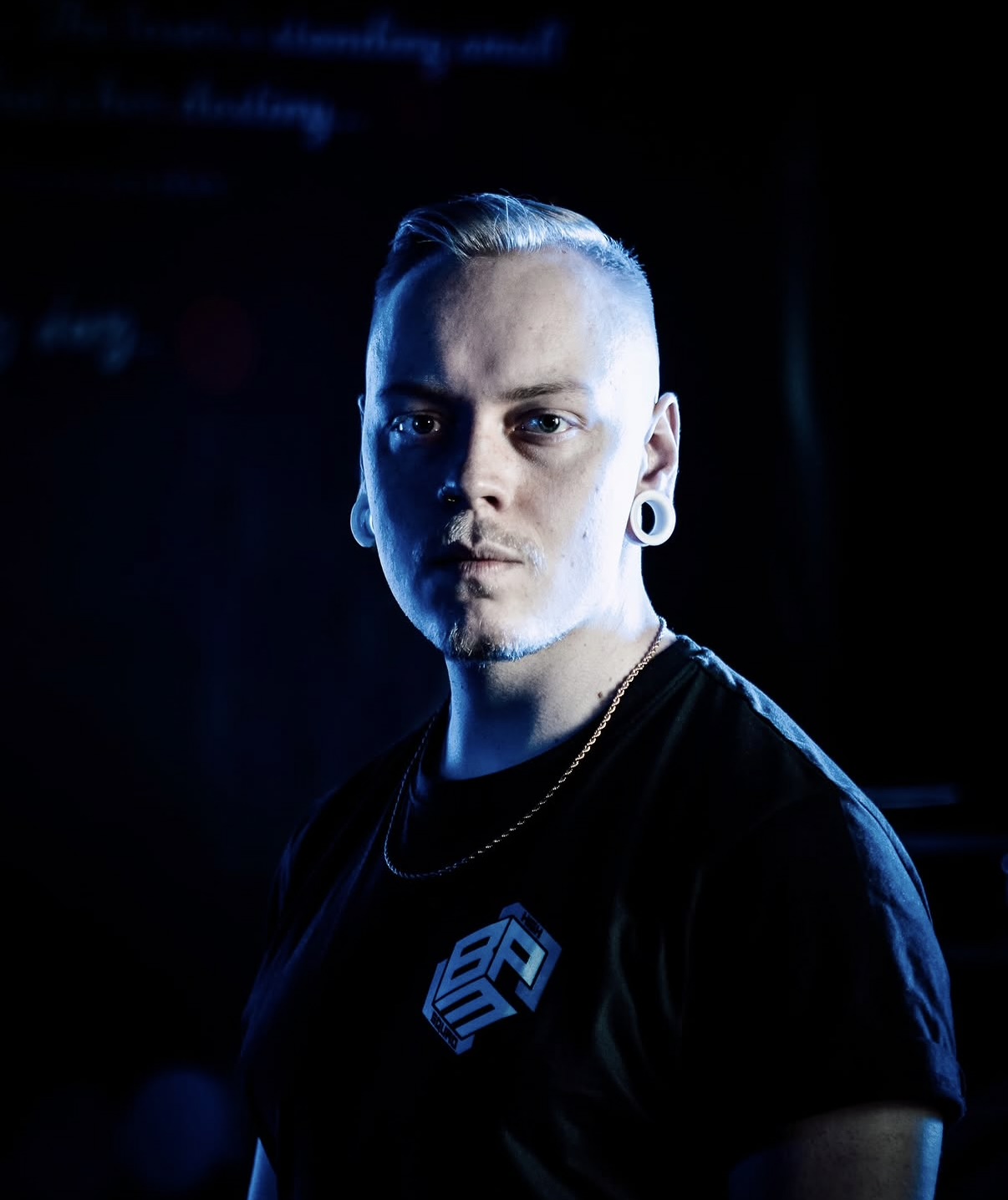 Portrait of KNST in blue stage light